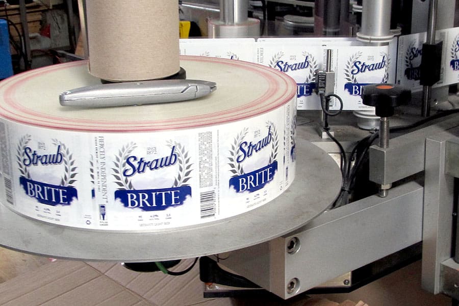 Bottle labels on labeling machine at brewery