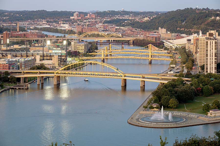 Three identical yellow bridges in background crossing river