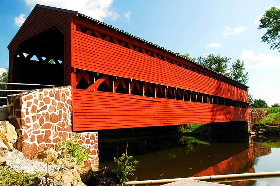 Red covered bridge with brown stone abutments