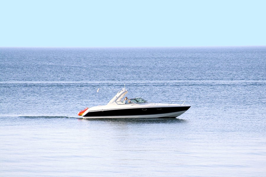 Pleasure boat speeds across the calm lake water
