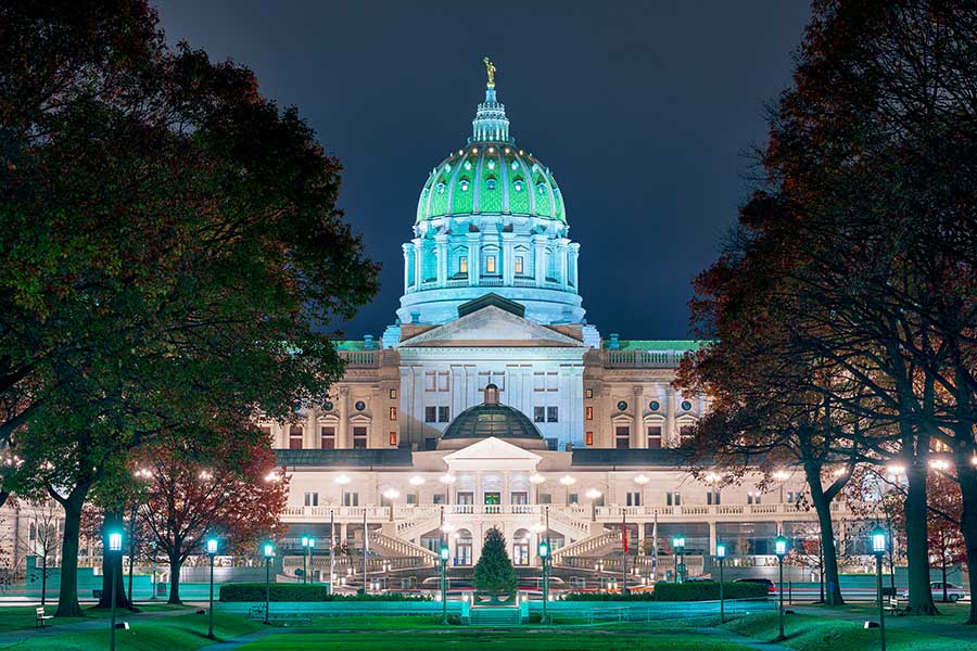 Harrisburg, Pennsylvania, state capitol building at dusk lit with bright lights