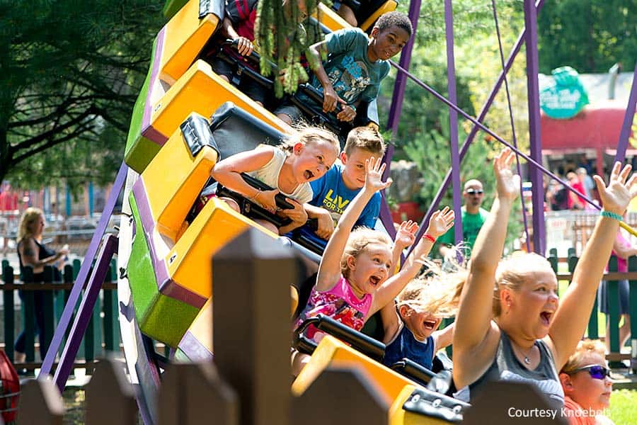 Happy kids ride the Kozmos Kurves roller coaster