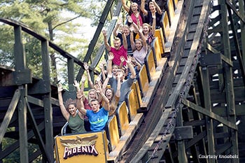 Adrenaline junkie ride the Phoenix, a wooden roller coaster